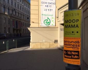 Banner at the entrance of the school stating: Climate Justice, Now.
